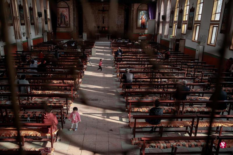 Believers gather at the government-sanctioned Catholic church before a mass on Palm Sunday in Youtong village, Hebei province, China, March 25, 2018. Choosing a church can be complicated in China under the rule of the officially atheist Communist Party - especially in Youtong village, where roughly half the 5,000 residents are Catholics. PHOTO: REUTERS