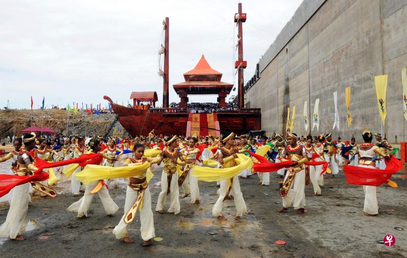 In this file photo taken on August 15, 2010 Sri Lankan dancers perform at the site of a new port under construction at the southern town of Hambantota. PHOTO: AFP