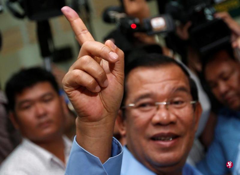 Cambodia's Prime Minister and President of the Cambodian People's Party (CPP) Hun Sen shows his stained finger at a polling station during a general election in Takhmao, Kandal province, Cambodia July 29, 2018. PHOTO: REUTERS