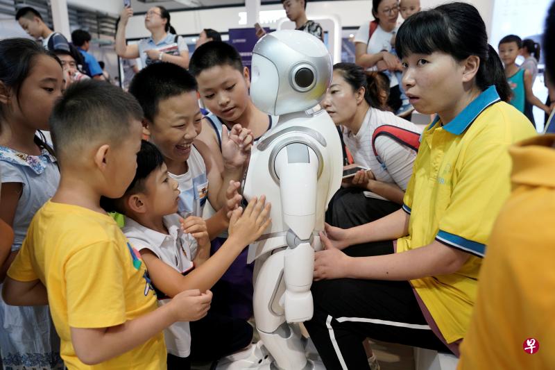 Children play with an iPal robot at Avatarmind's booth at the World Robot Conference (WRC) in Beijing, China August 17, 2018. PHOTO: REUTERS